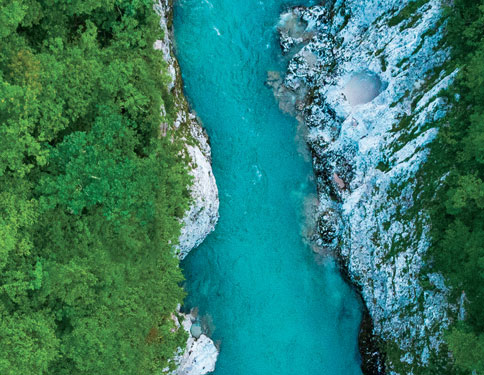 Aerial photo of a turquoise river and forest